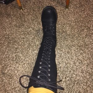 Knee-length lace up tall black boots